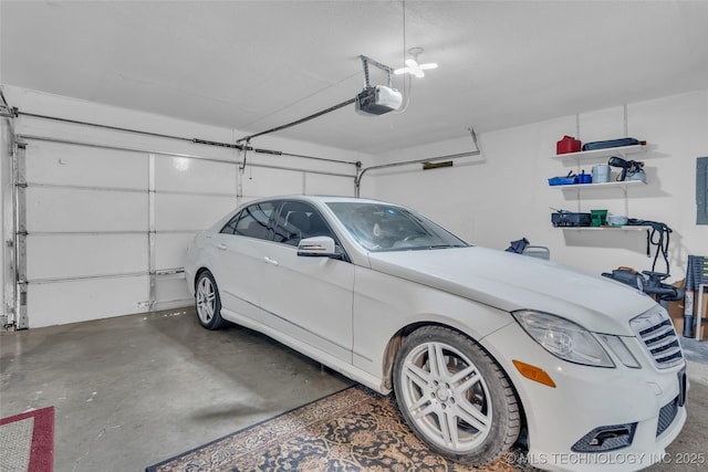 garage featuring electric panel and a garage door opener