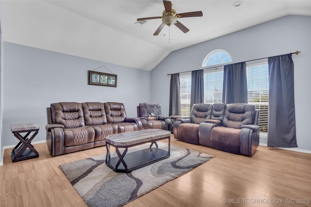 living room with a ceiling fan, visible vents, vaulted ceiling, and wood finished floors