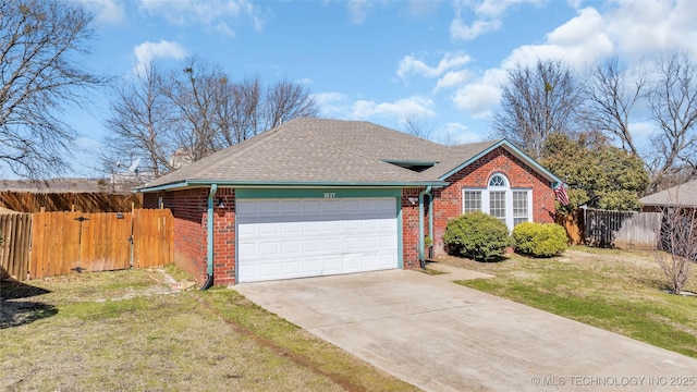 view of front facade featuring brick siding, a shingled roof, fence, driveway, and a front yard