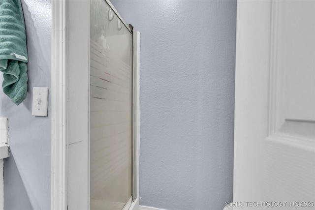 2517 Westwood, Ardmore, OK 73401 - bathroom featuring a shower stall and a textured wall
