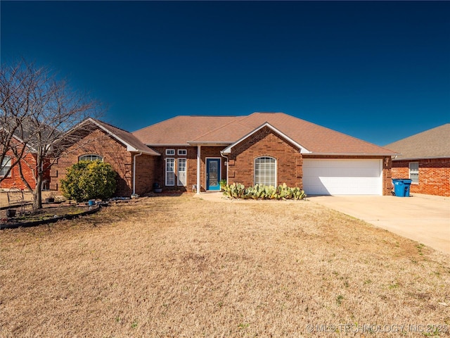 single story home with a front lawn, roof with shingles, concrete driveway, a garage, and brick siding