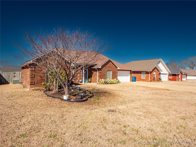 ranch-style house with a front yard, a garage, brick siding, and driveway