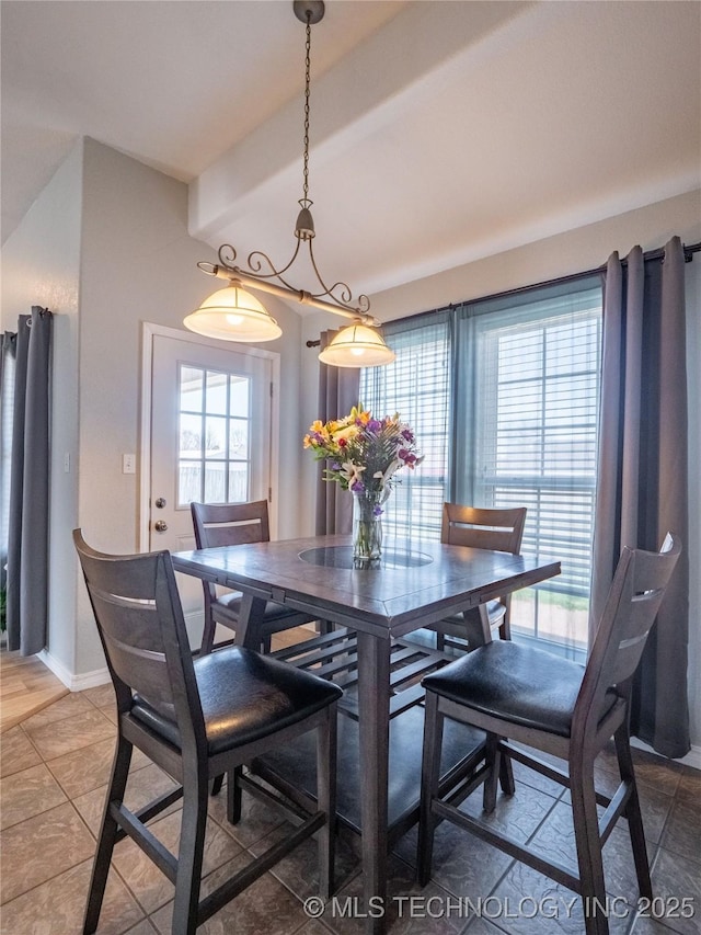 dining area featuring plenty of natural light and baseboards