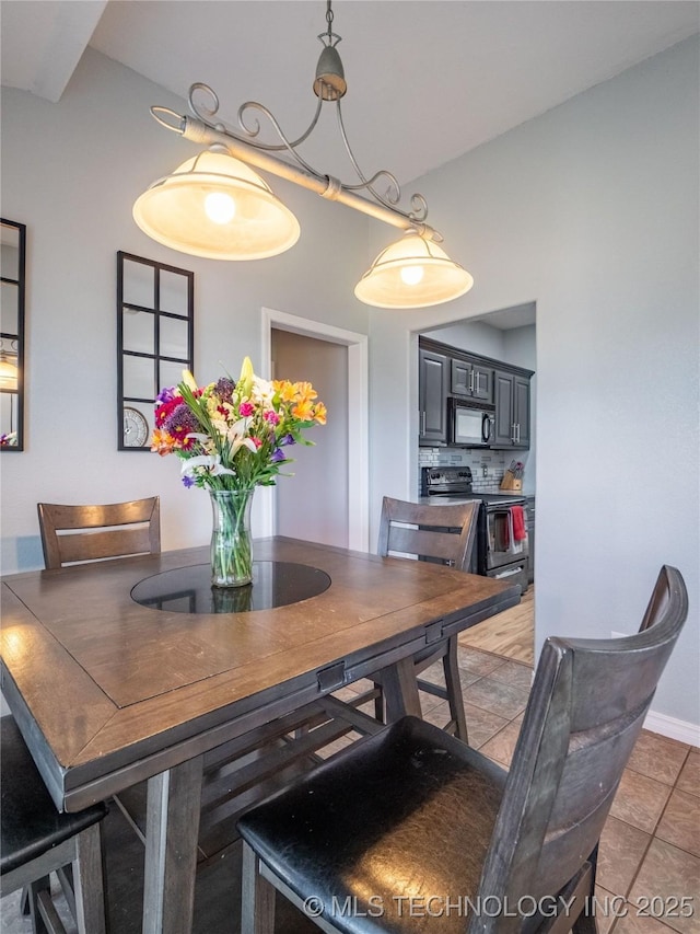 dining area with light tile patterned flooring and baseboards