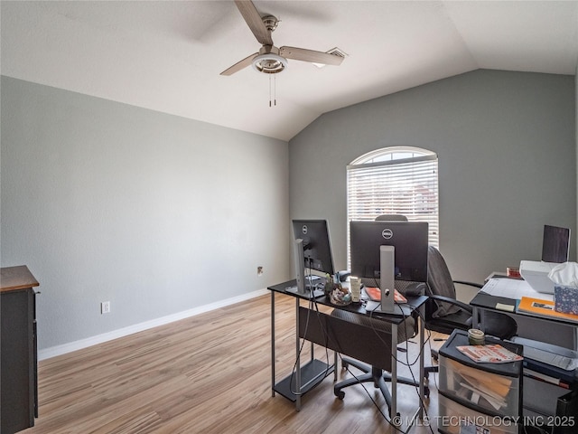 office with baseboards, lofted ceiling, wood finished floors, and a ceiling fan