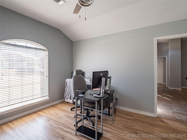 home office featuring wood finished floors, a ceiling fan, baseboards, and vaulted ceiling