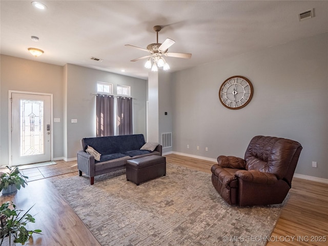 living area with wood finished floors, a healthy amount of sunlight, and visible vents