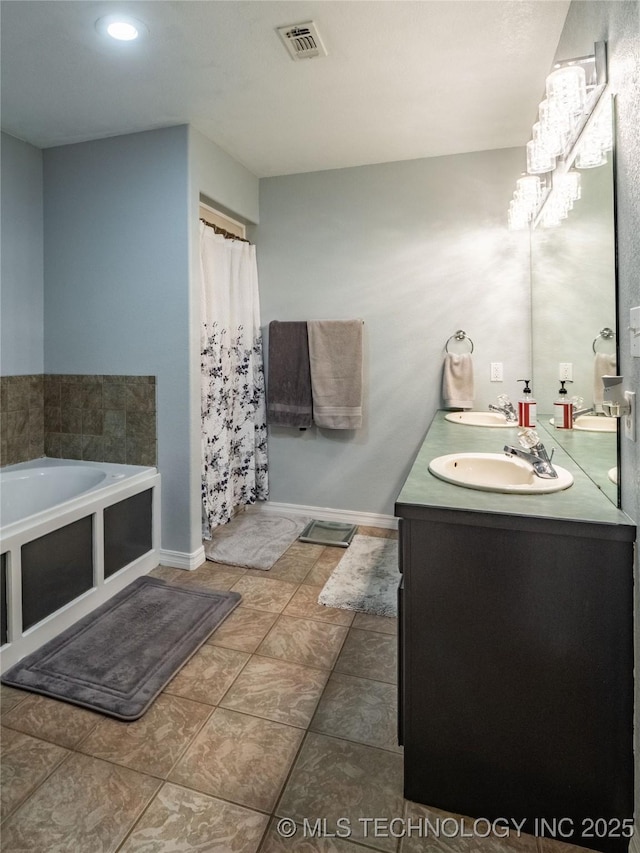 bathroom featuring double vanity, a bath, visible vents, and a sink