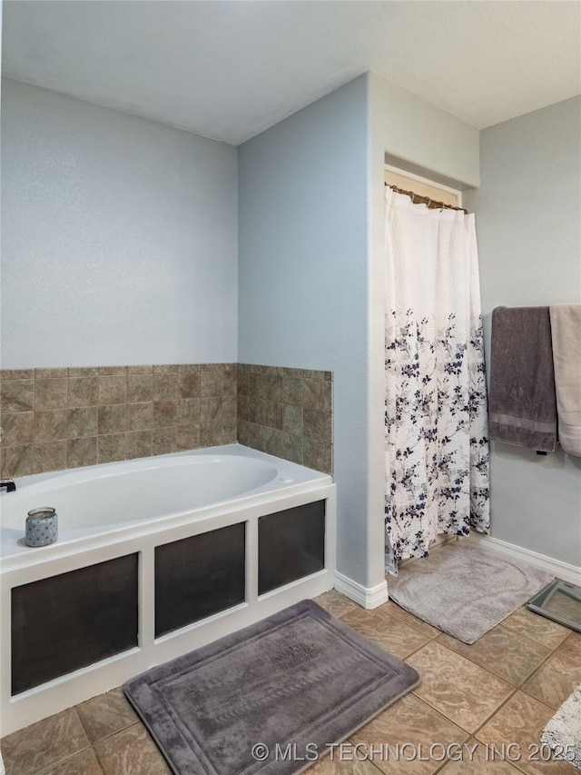 bathroom featuring curtained shower, tile patterned floors, a bath, and baseboards