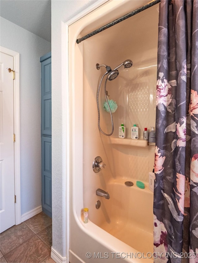 full bathroom featuring tile patterned floors, baseboards, and shower / tub combo with curtain