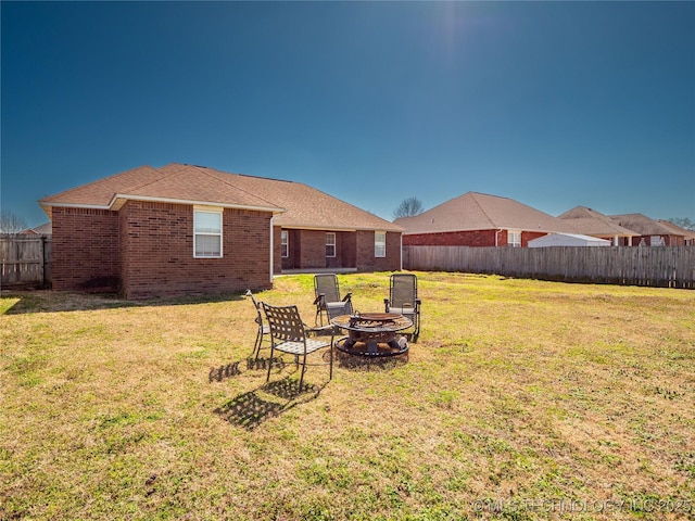 view of yard featuring fence and an outdoor fire pit