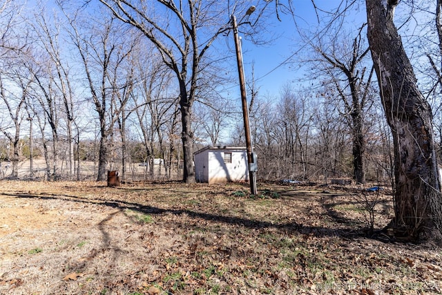 view of yard with an outbuilding and a shed