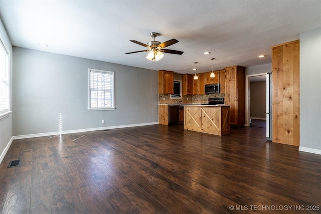 kitchen with visible vents, appliances with stainless steel finishes, open floor plan, and dark wood-style flooring