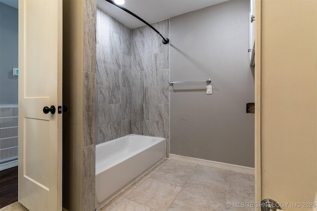 full bath featuring bathtub / shower combination and baseboards