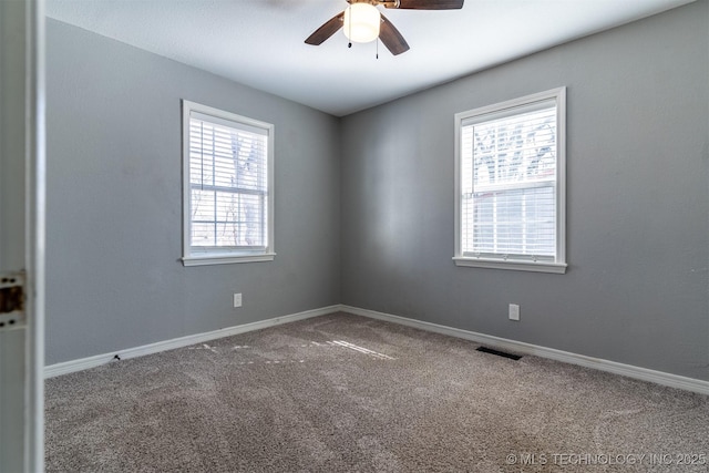 unfurnished room featuring carpet, visible vents, ceiling fan, and baseboards