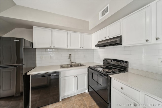 kitchen featuring under cabinet range hood, a sink, visible vents, light countertops, and black appliances