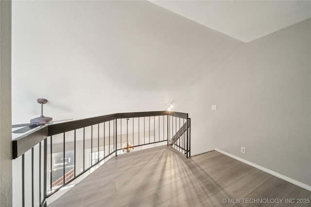 interior space featuring ceiling fan, wood finished floors, and baseboards