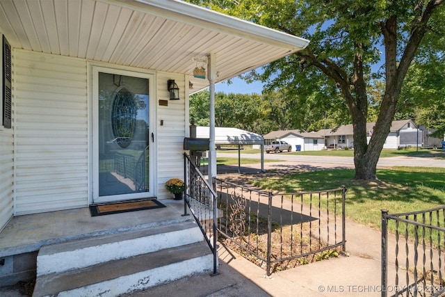 property entrance featuring a lawn