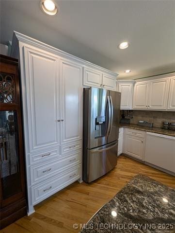 kitchen featuring white cabinets, decorative backsplash, stainless steel fridge with ice dispenser, light wood-type flooring, and recessed lighting