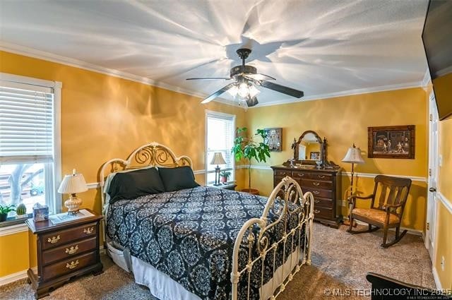 bedroom featuring dark carpet, crown molding, baseboards, and a ceiling fan