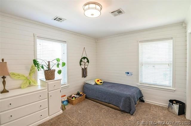 carpeted bedroom featuring visible vents