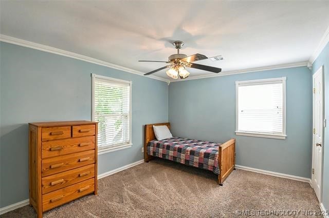 bedroom featuring carpet flooring, crown molding, baseboards, and ceiling fan