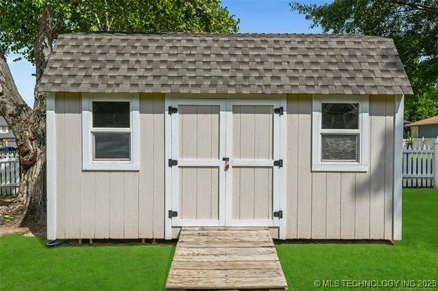 view of shed with fence