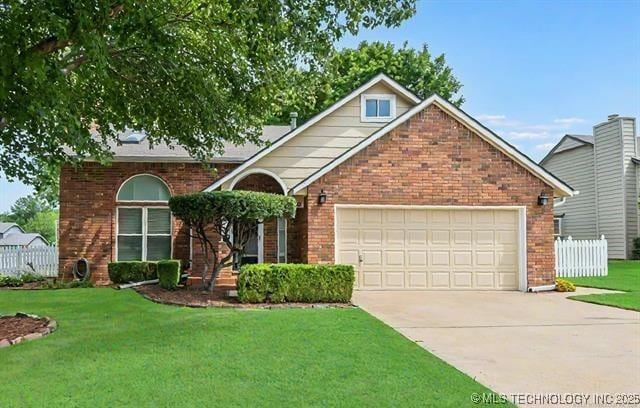 view of front of house featuring driveway, an attached garage, fence, a front lawn, and brick siding