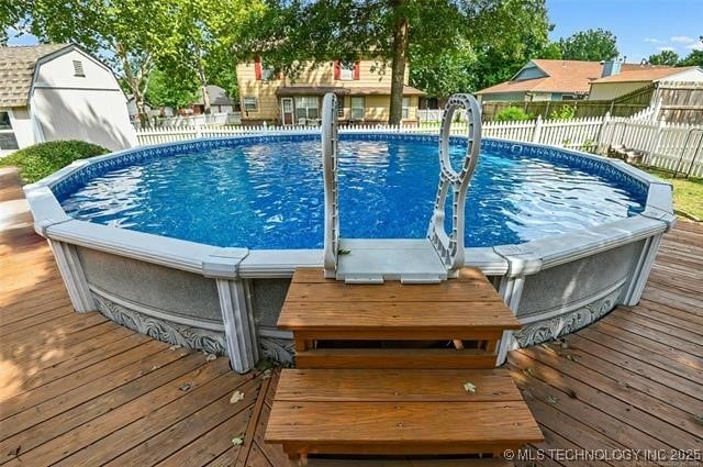 view of pool with a fenced in pool and fence