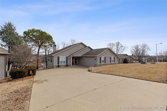 ranch-style home with a garage, driveway, and a chimney