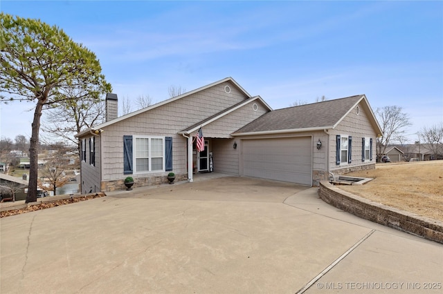 ranch-style home with stone siding, concrete driveway, a chimney, and an attached garage