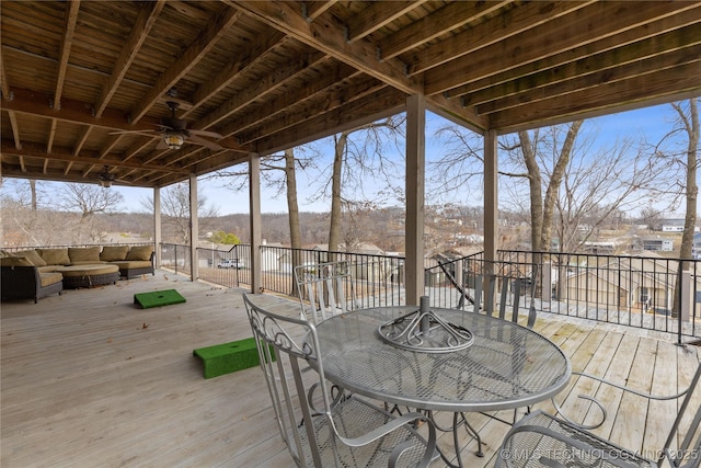 deck with a ceiling fan, outdoor dining space, and outdoor lounge area