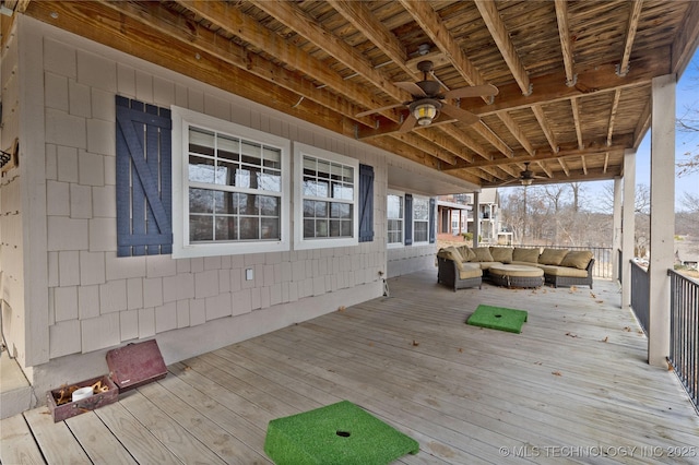 wooden deck featuring an outdoor hangout area and a ceiling fan