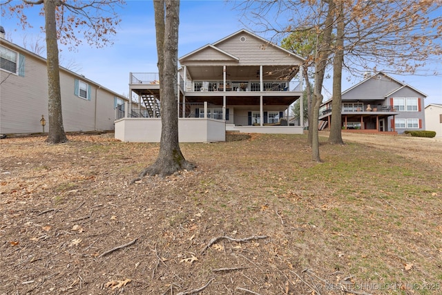 rear view of property with a ceiling fan