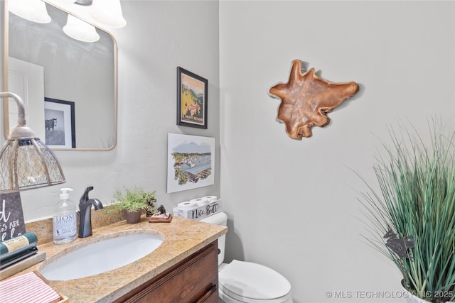 bathroom featuring toilet and vanity