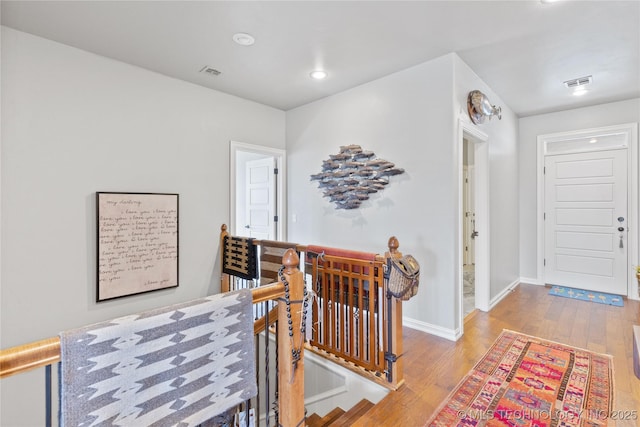 entryway featuring recessed lighting, visible vents, baseboards, and wood finished floors