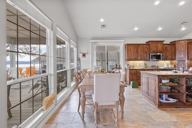 dining room with lofted ceiling, visible vents, and recessed lighting