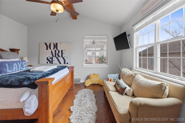 bedroom with vaulted ceiling with beams, ceiling fan, multiple windows, and wood finished floors