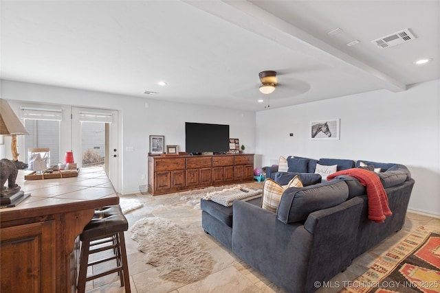 living area with ceiling fan, recessed lighting, visible vents, baseboards, and beamed ceiling