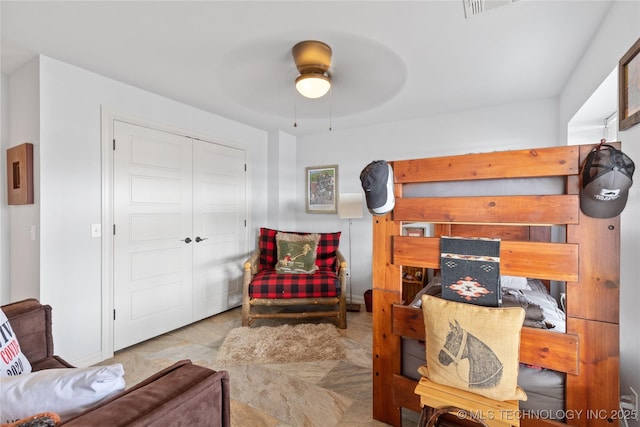 interior space with ceiling fan, visible vents, and a closet