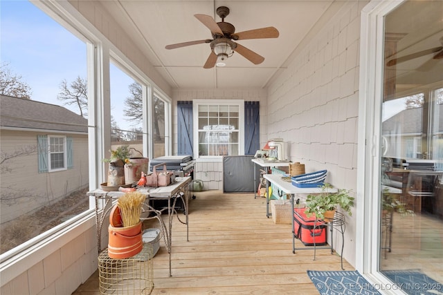 sunroom / solarium with a ceiling fan and vaulted ceiling