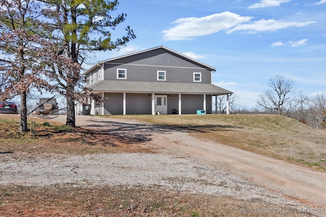 farmhouse with driveway and covered porch