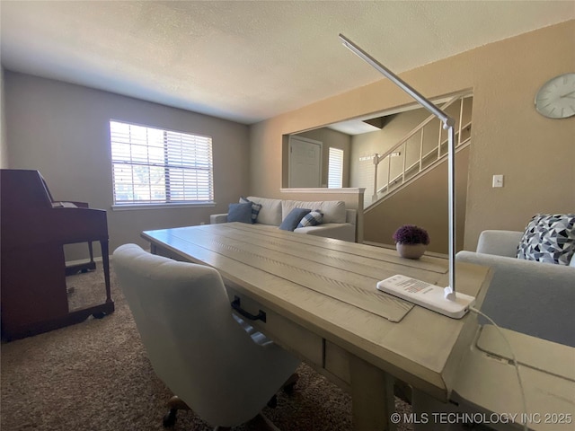 home office featuring a textured ceiling and carpet