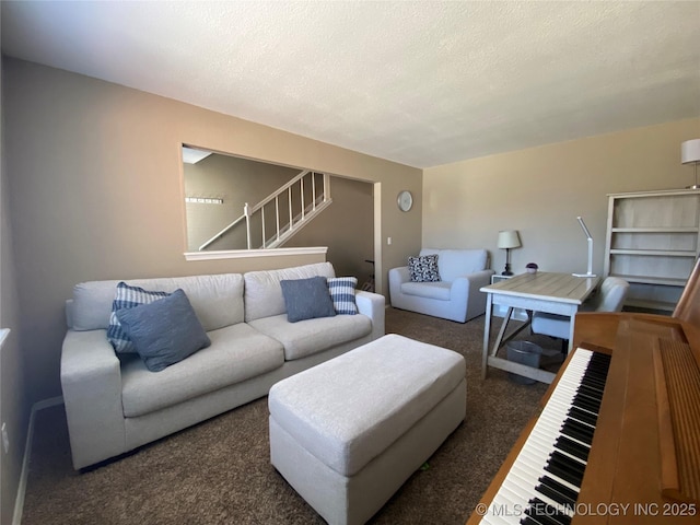 carpeted living room with a textured ceiling and stairs