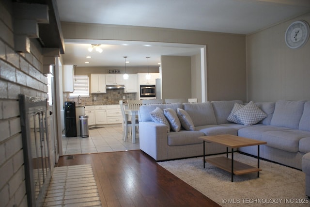 living area featuring a fireplace and light wood finished floors