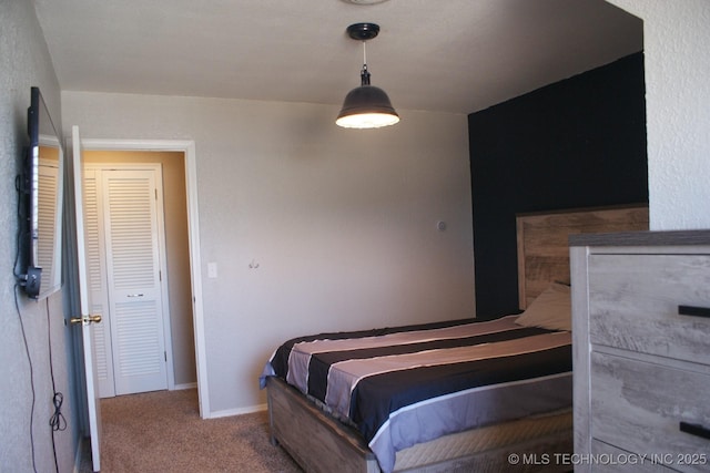 carpeted bedroom featuring baseboards