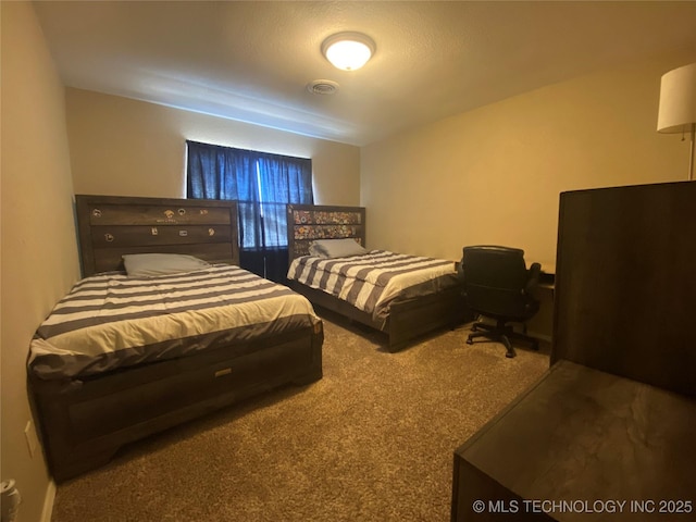 carpeted bedroom featuring visible vents