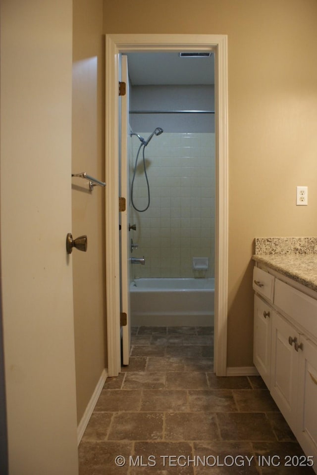 full bathroom with tub / shower combination, vanity, and baseboards