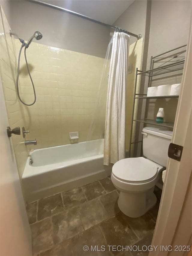 bathroom featuring shower / bath combo and toilet