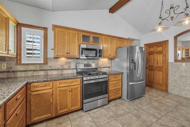 kitchen with lofted ceiling with beams, appliances with stainless steel finishes, brown cabinetry, dark stone countertops, and glass insert cabinets